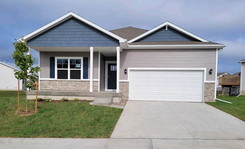 A one-story Neuville home with a two-car garage, covered front porch, and a combination of plank and shake siding with a stone water table accent.