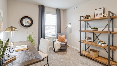 Second bedroom with small window staged as an office