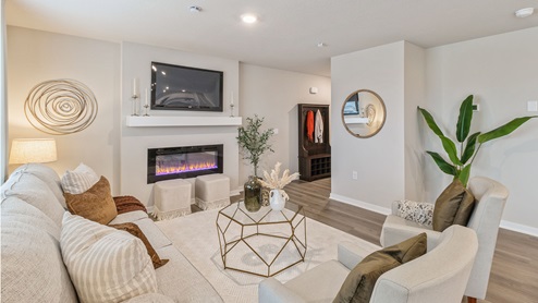Living room with large white couch and two white chairs