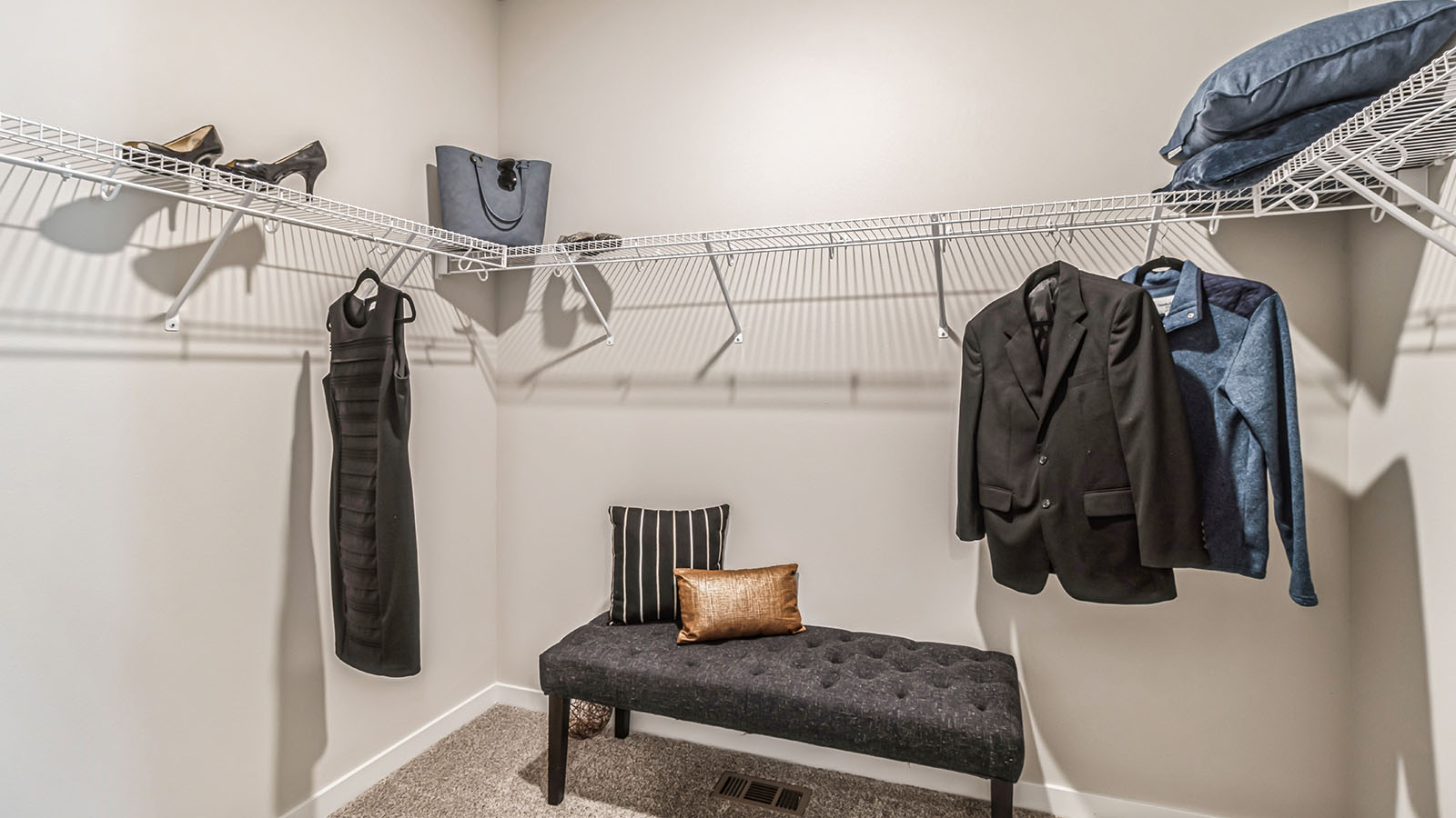 Walk-in closet with clothes and shelving