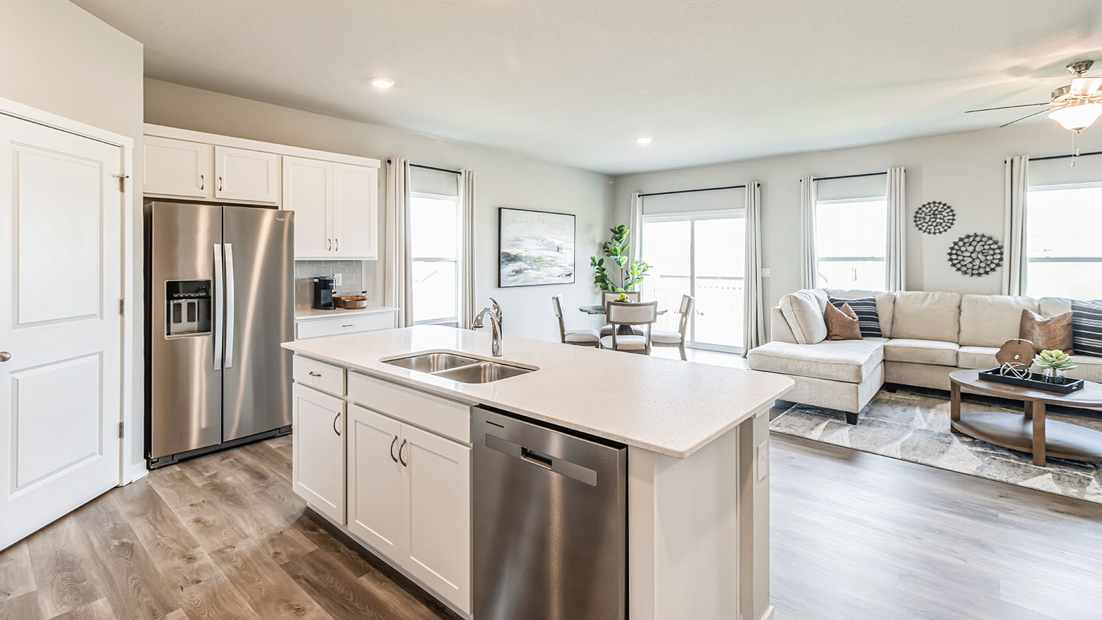 Kitchen island with dishwasher overlooking living room and dining area