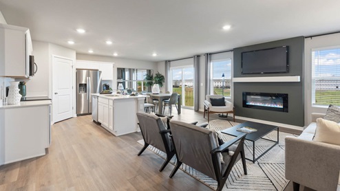 Living room with two bright windows next to glass sliding doors