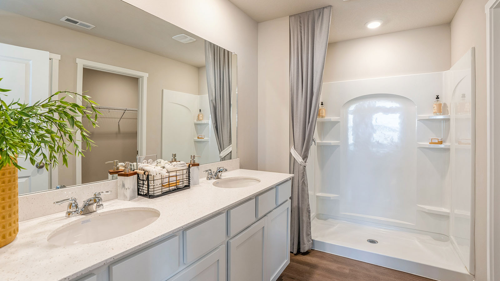 Primary bathroom with dual sinks and shower