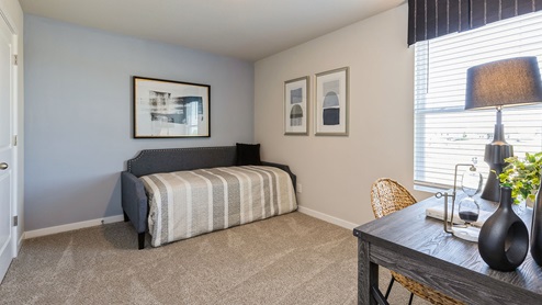 First bedroom with small bed and desk