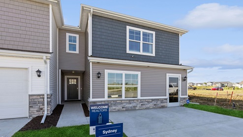 exterior of sydney townhome with yard signs