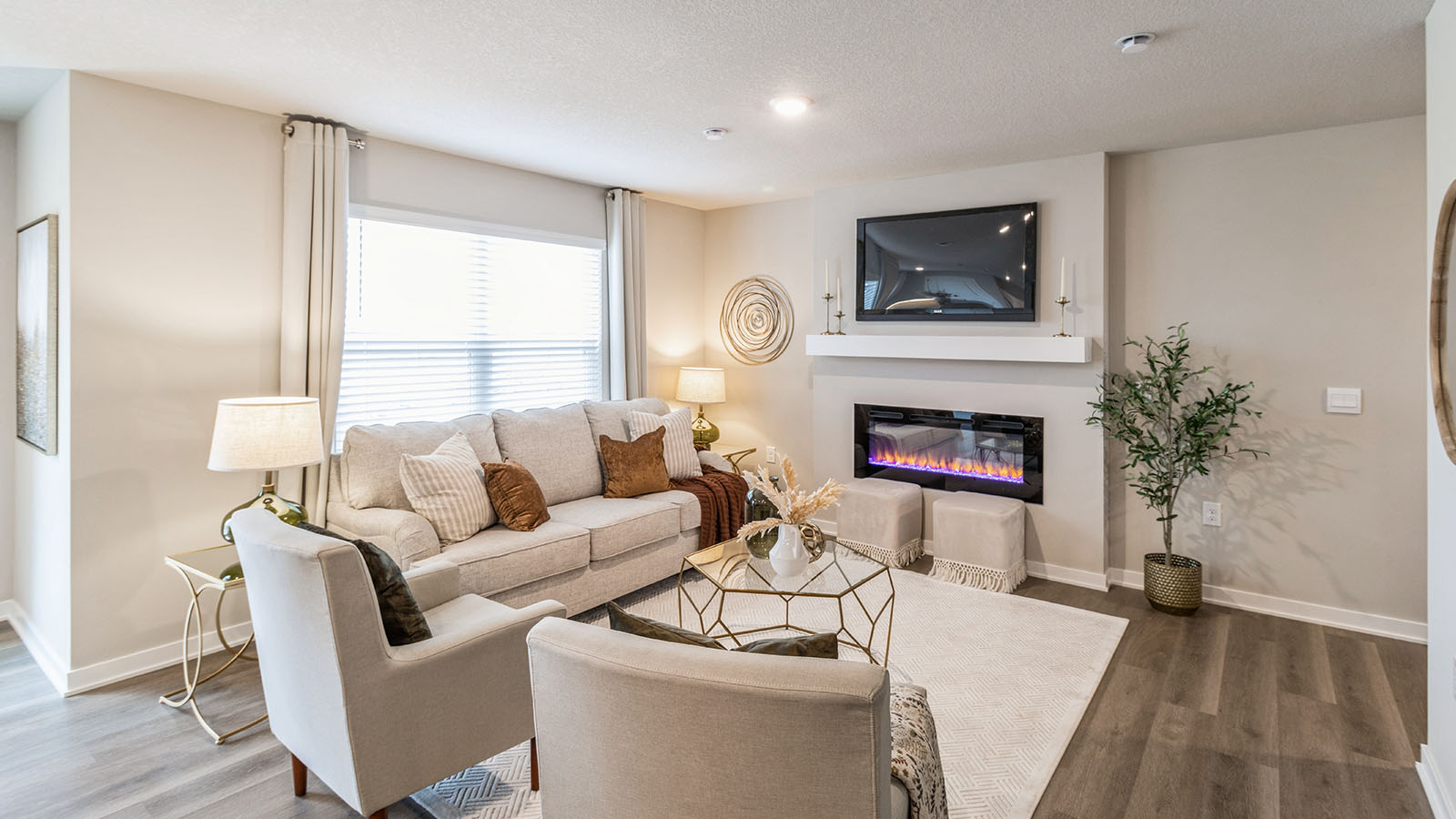 Spacious living room with electric fireplace and mounted tv