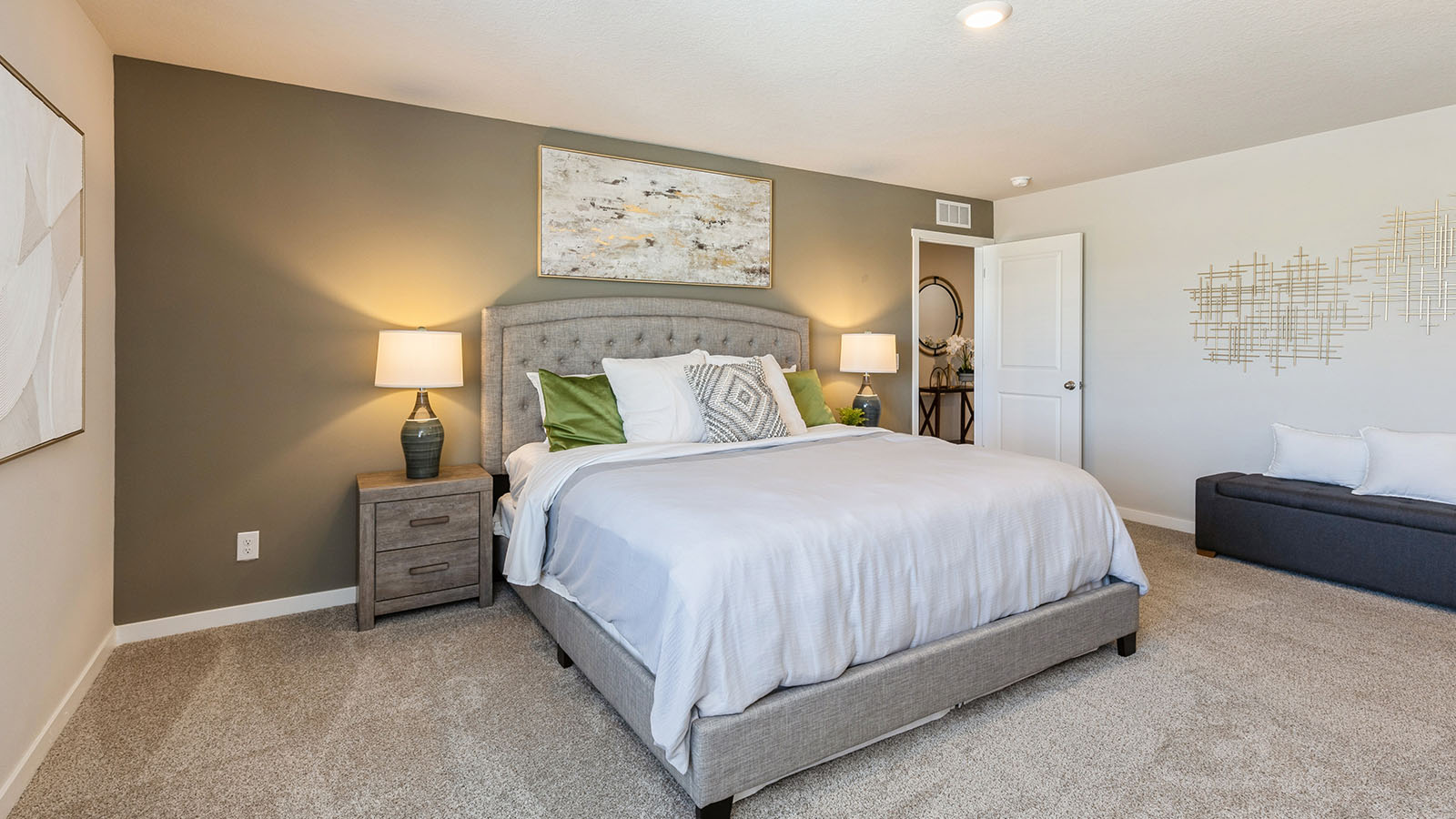 Primary bedroom with green accent wall and nightstands