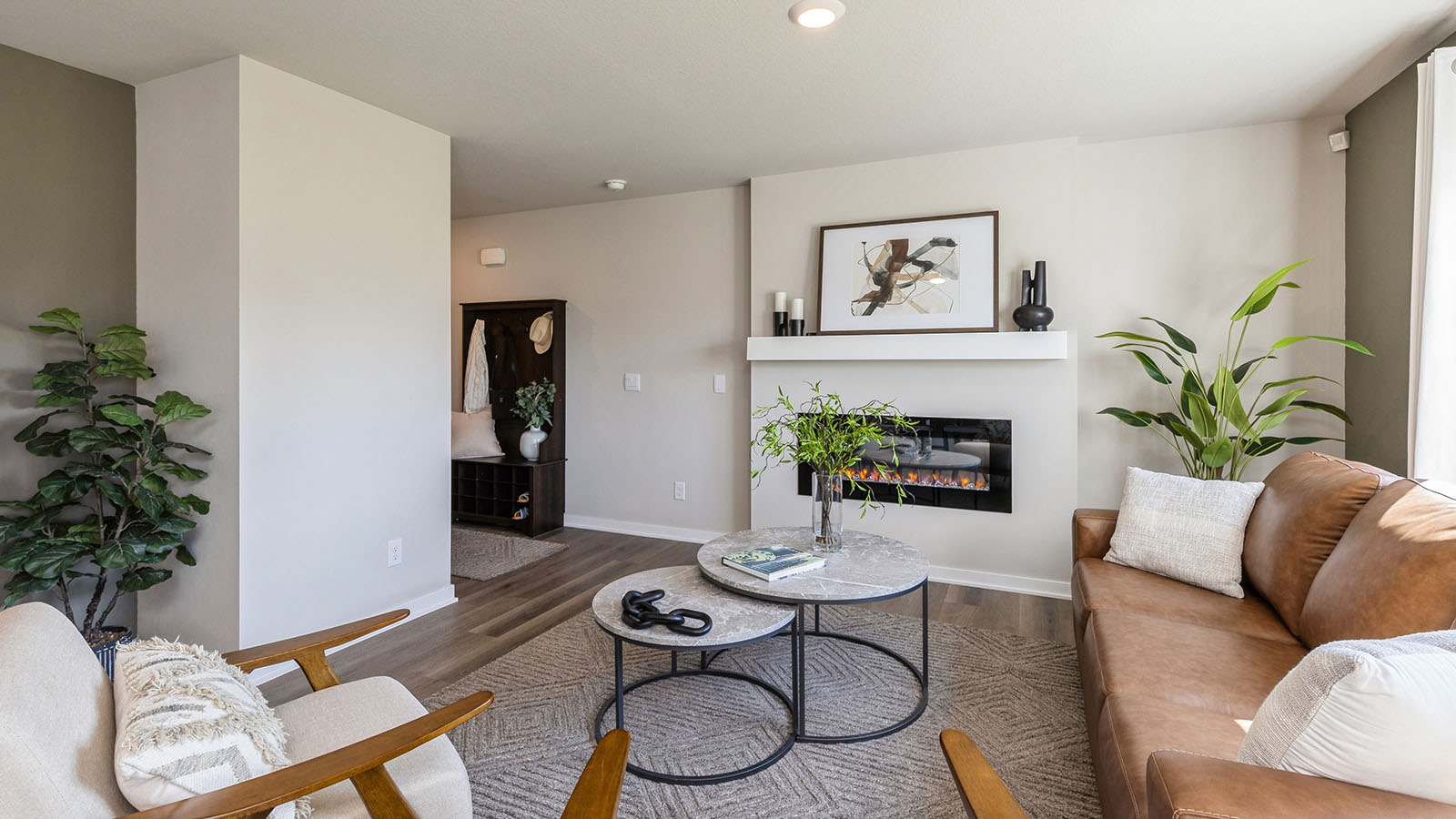 Living room with brown leather couch and white coffee table