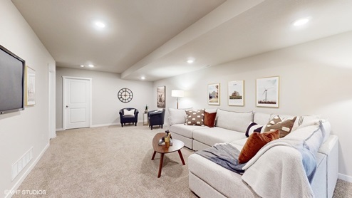 Finished basement with large white sectional