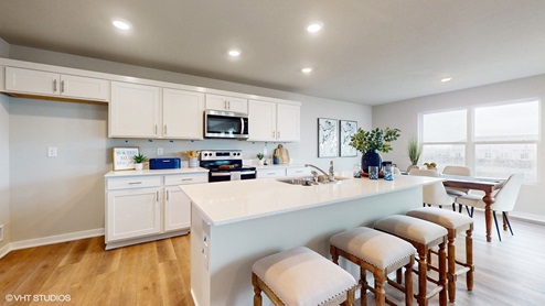 Spacious kitchen with an island and barstools