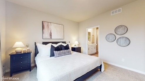 Primary bedroom with white bed and two black nightstands