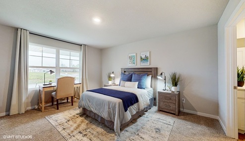 Primary bedroom with two full length mirrors next to bed