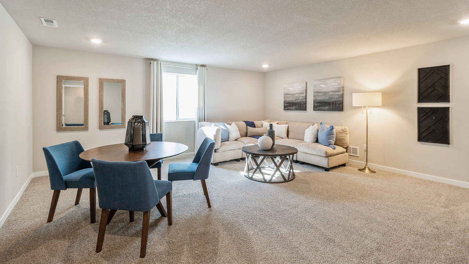 Spacious finished basement with egress window and large white sectional