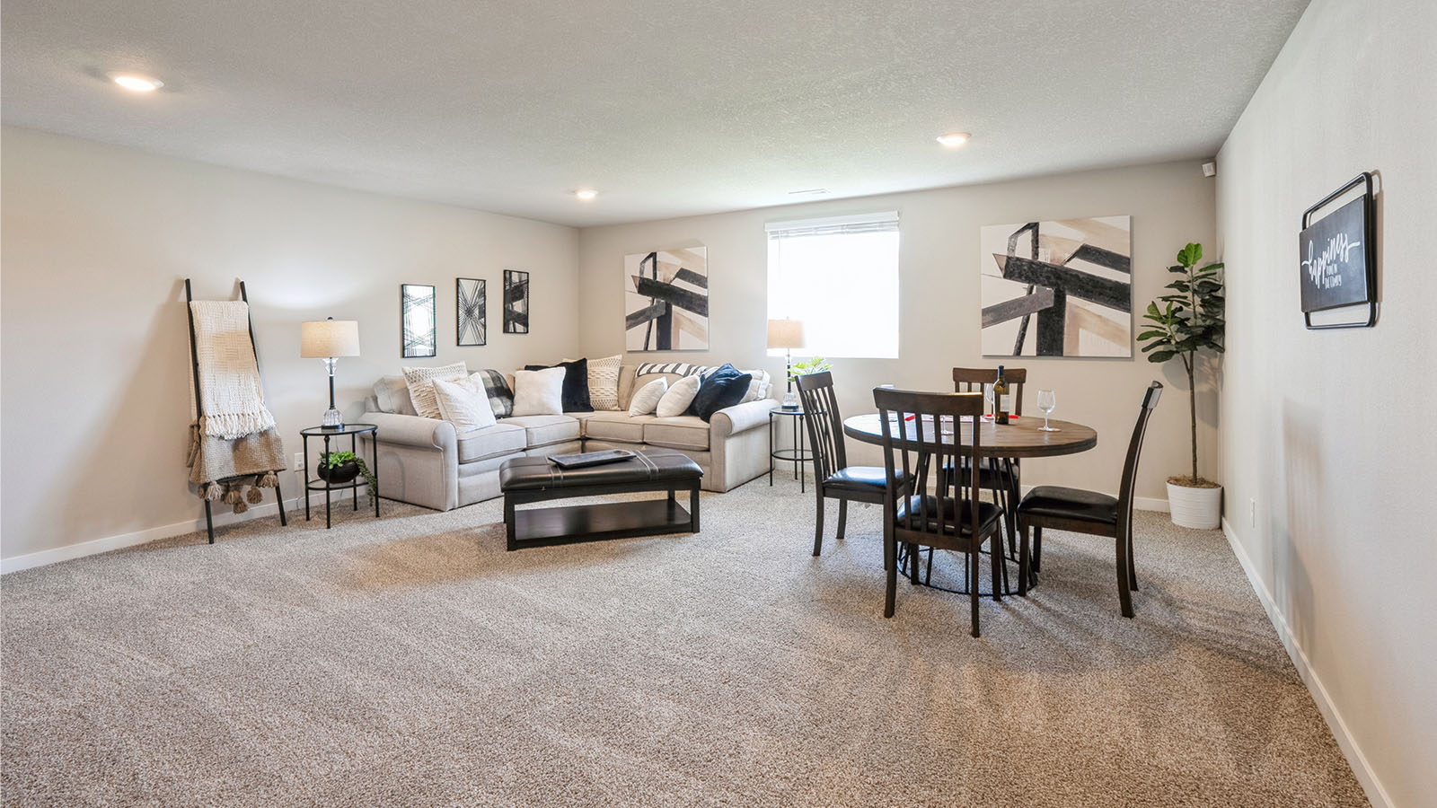 Finished basement with carpeted floors and a window.