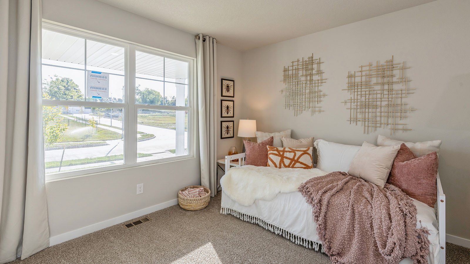 Bedroom with large window for natural lighting.