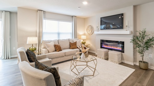 bright and spacious living room with large window and electric fireplace