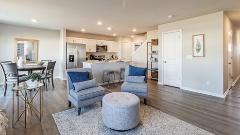 two grey living room chair overlooking dining area and kitchen
