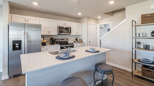 modern kitchen with stainless-steel appliances and quartz countertops