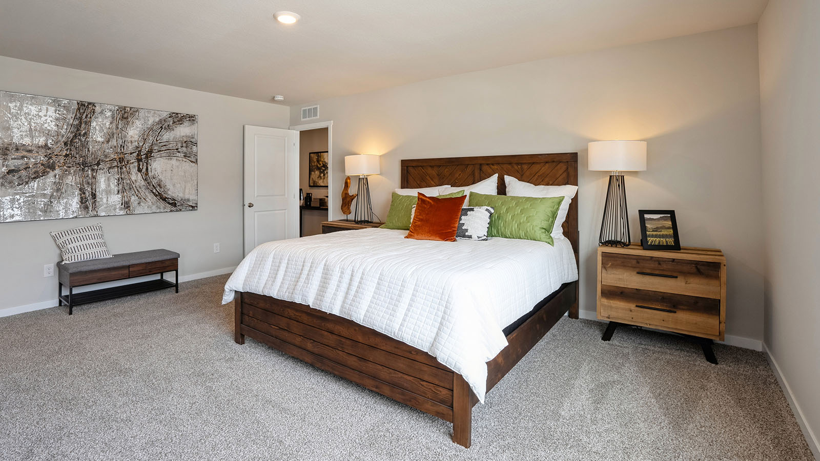 Primary bedroom with white queen bed and two wood nightstands