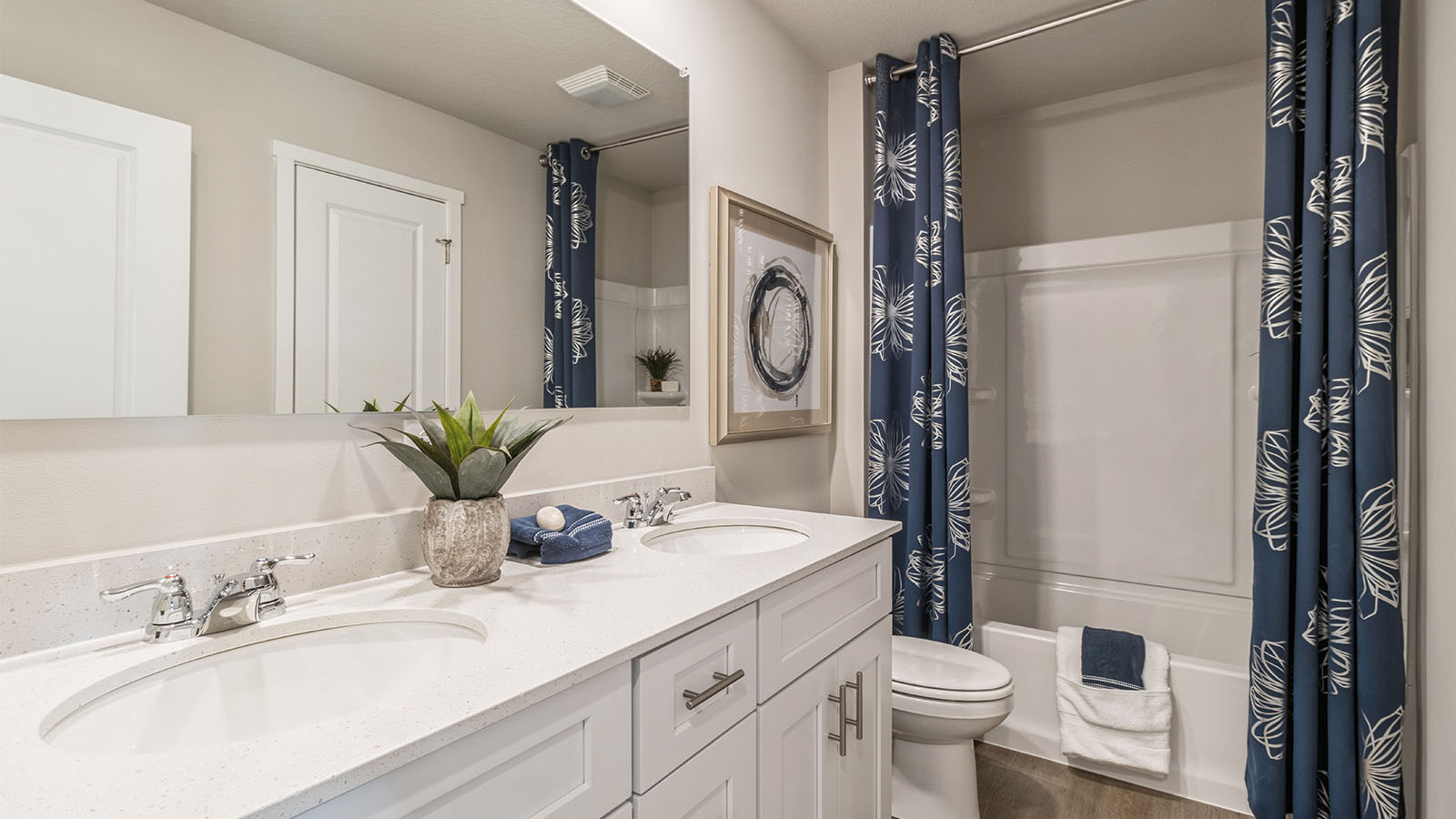 Bathroom with dual vanity sinks and a step in bathtub.
