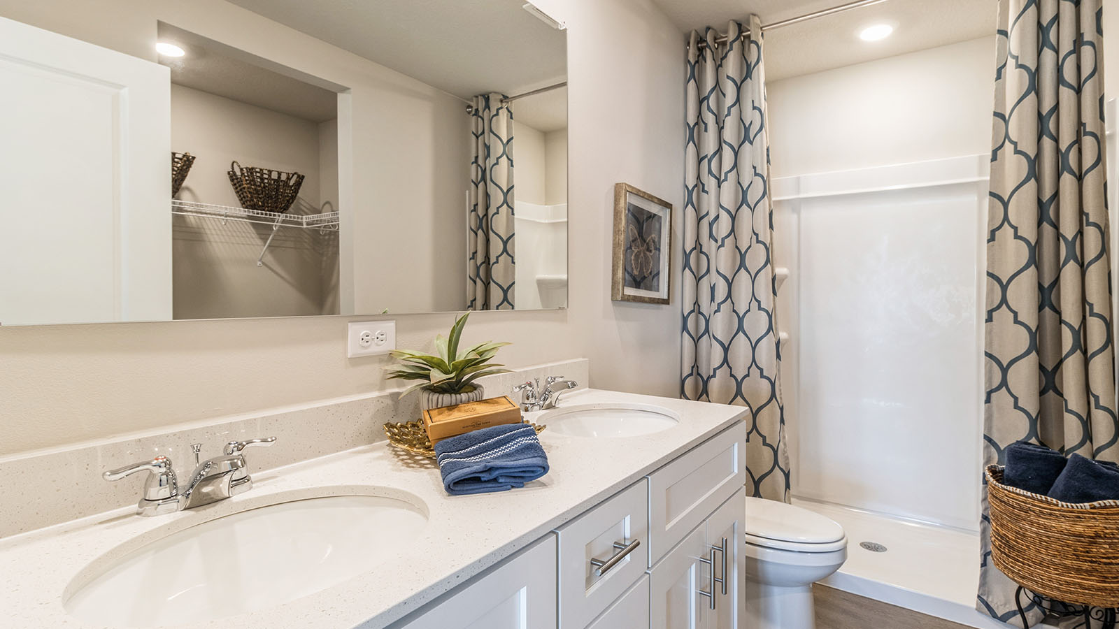 Primary bathroom with a double vanity sink and walk in shower.