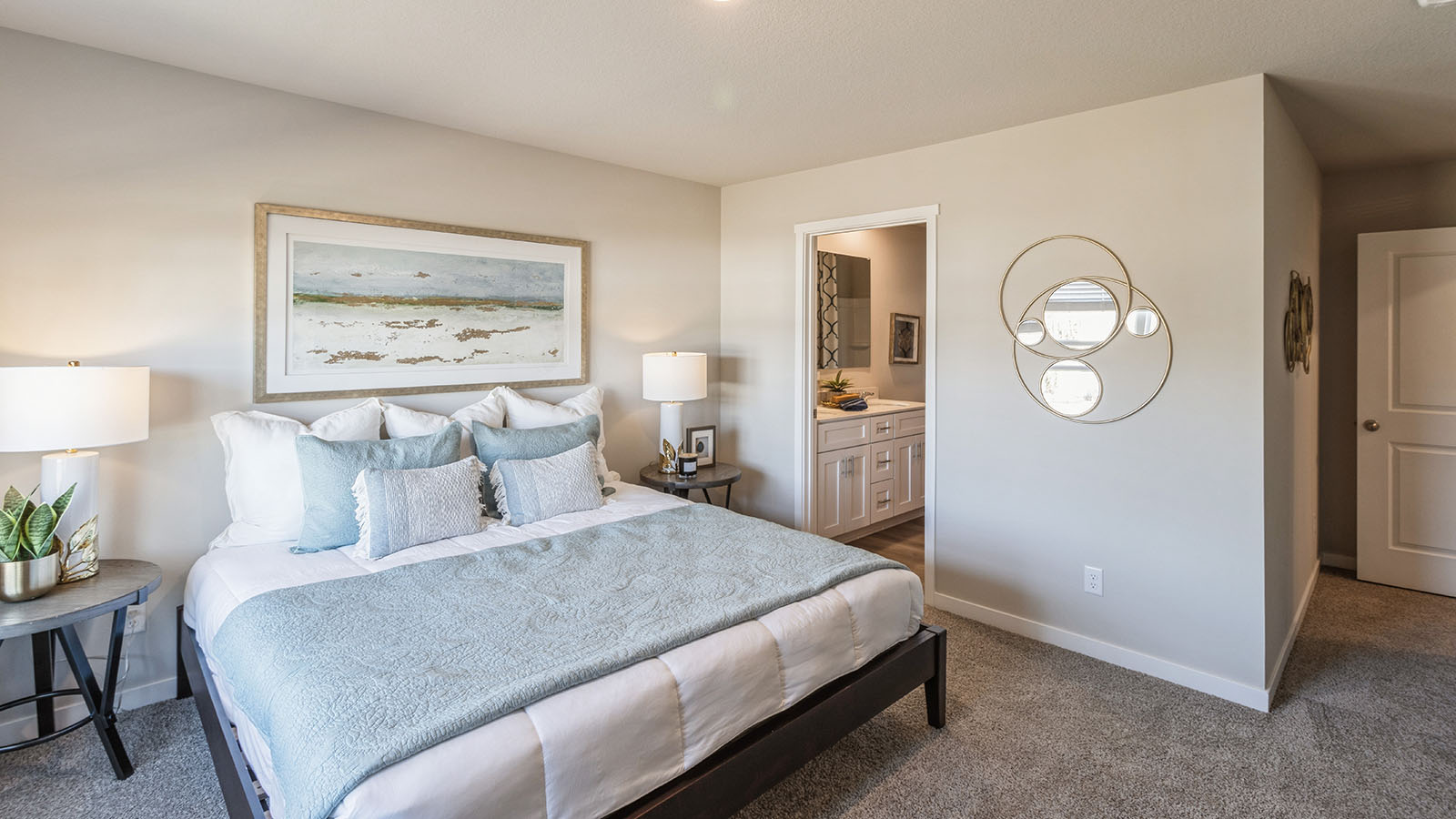 Bedroom with a large window and carpeted floors.