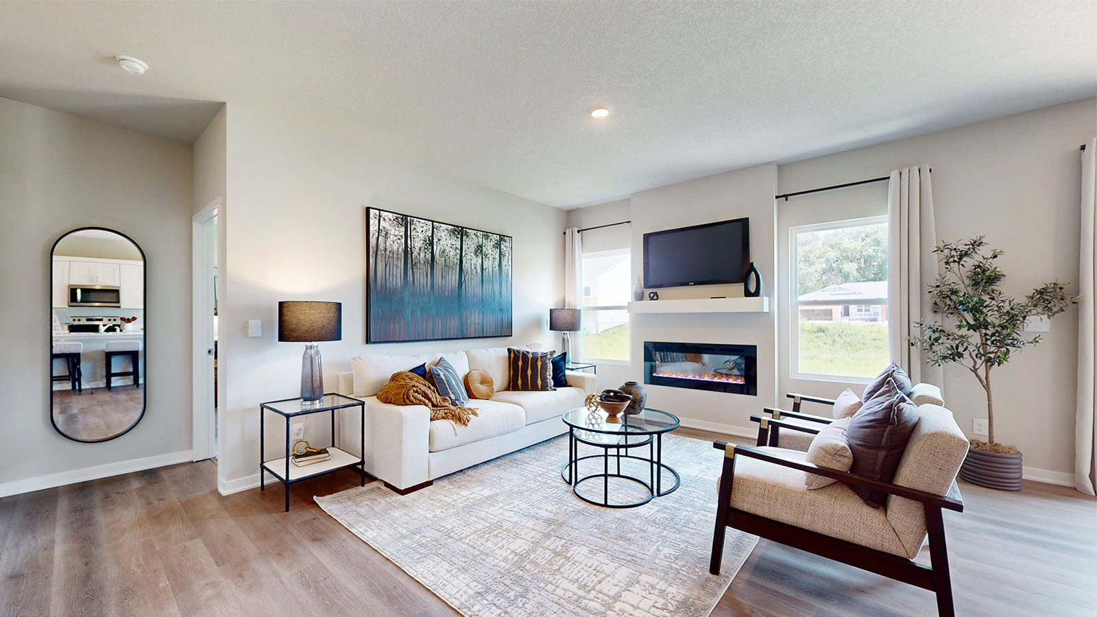 Bright living room with two windows and electric fireplace