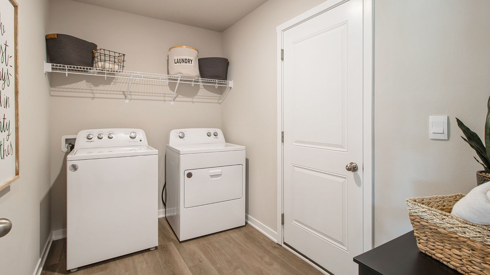 Laundry area with washer and dryer with white shelving above