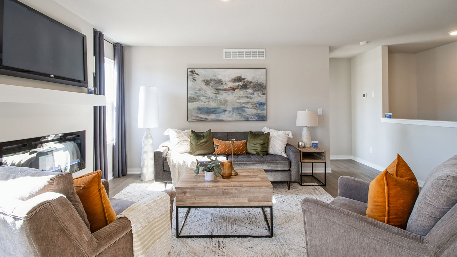 Bright Jack living room with grey love seat and two grey chairs