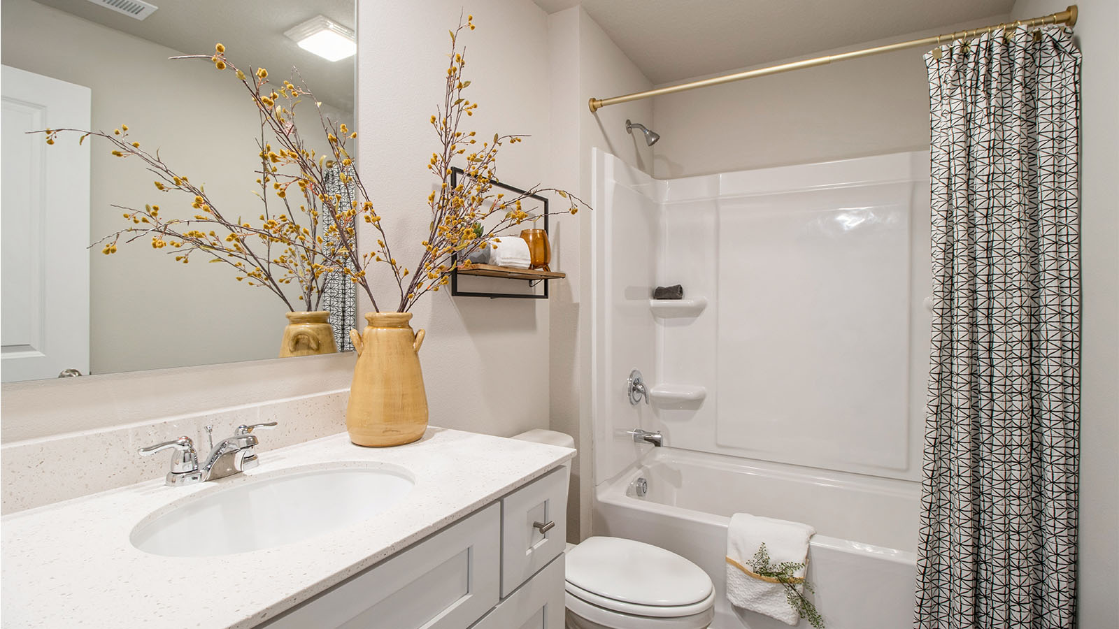 Second bathroom with white cabinetry and shower with bathtub