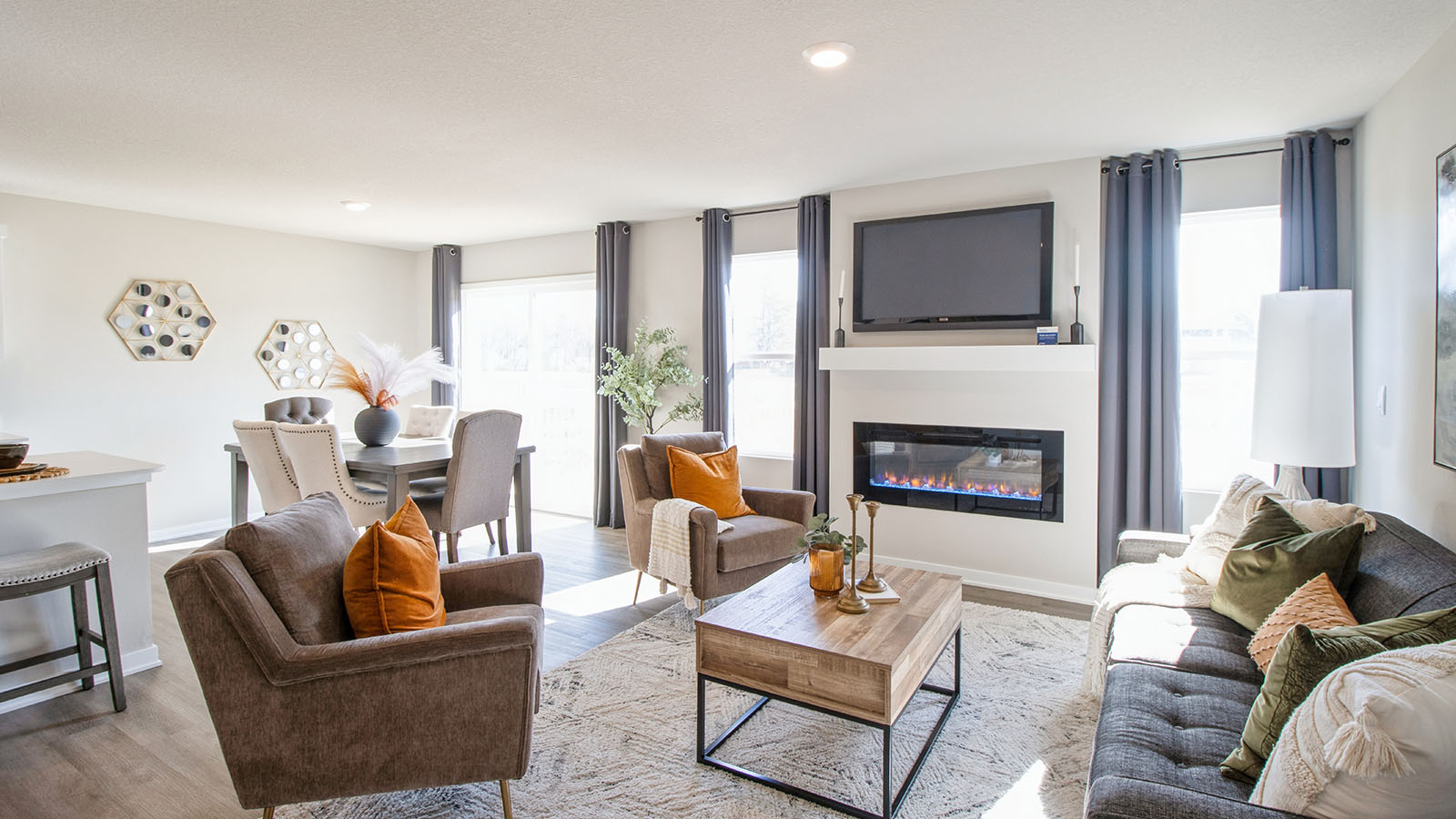 Open concept living room and dining area with lots of windows and natural light