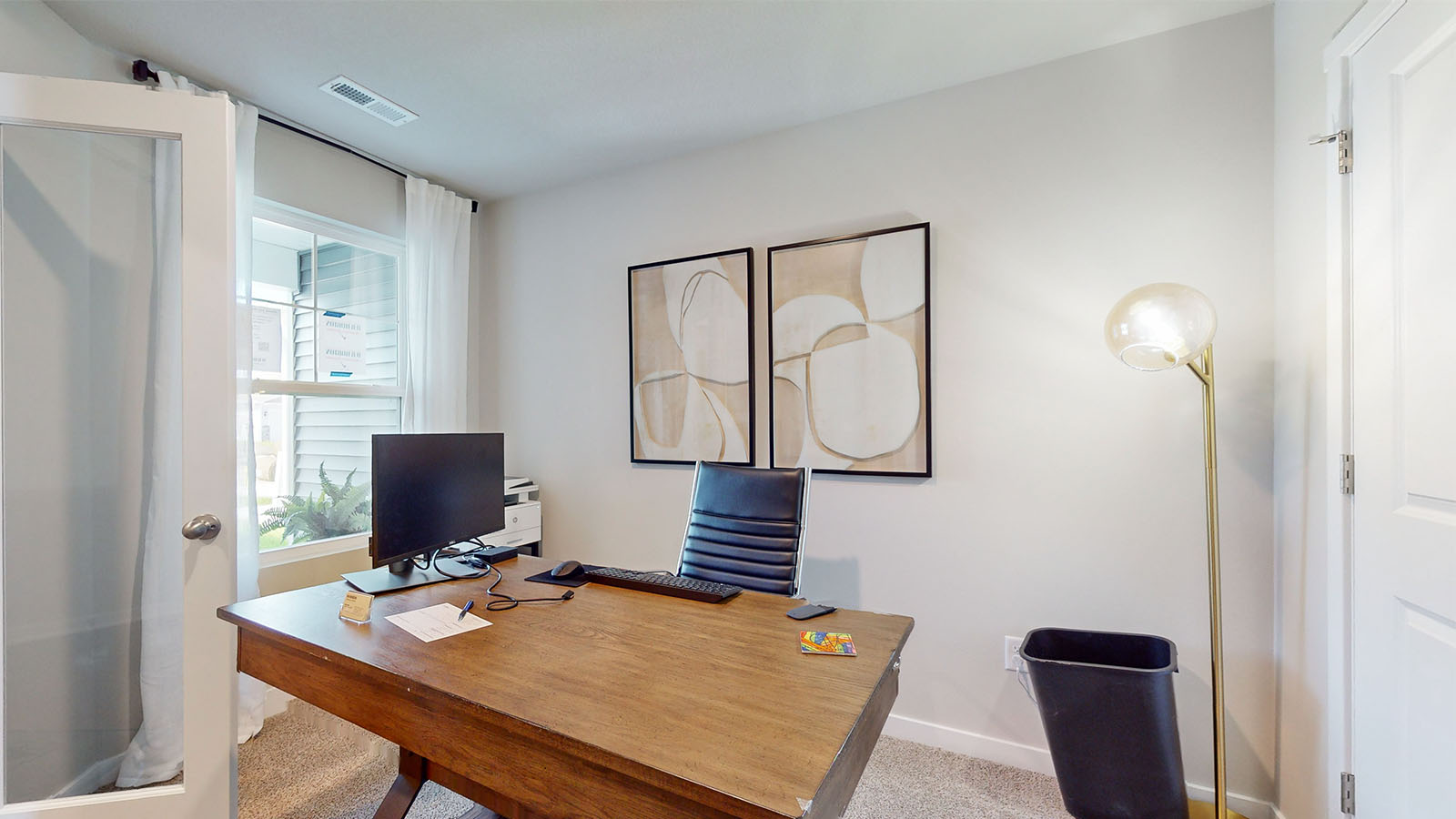 Bedroom with large window for natural lighting.