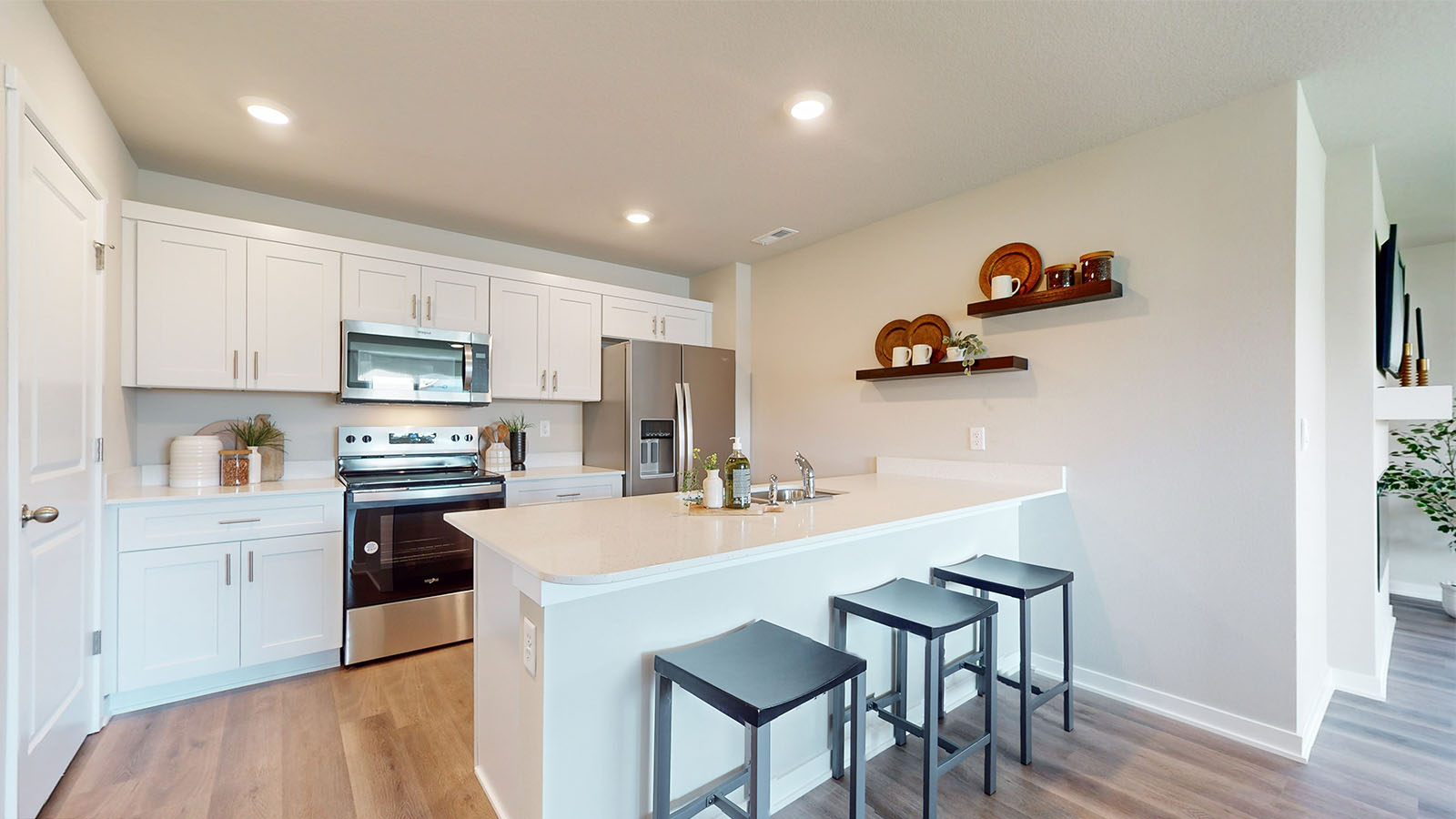 Kitchen with island and quartz countertops.