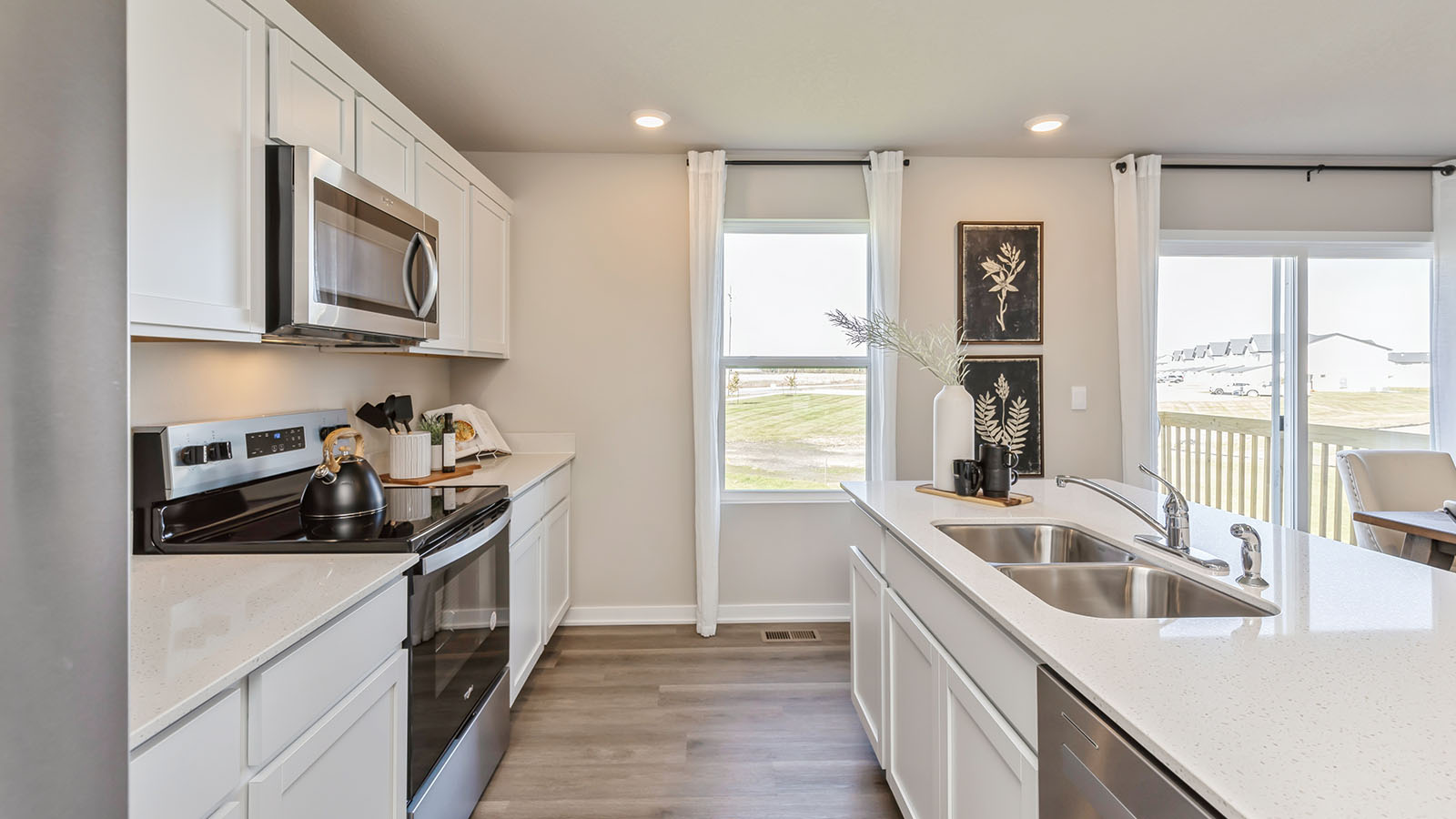 side view of kitchen with quartz countertops and dual sinks