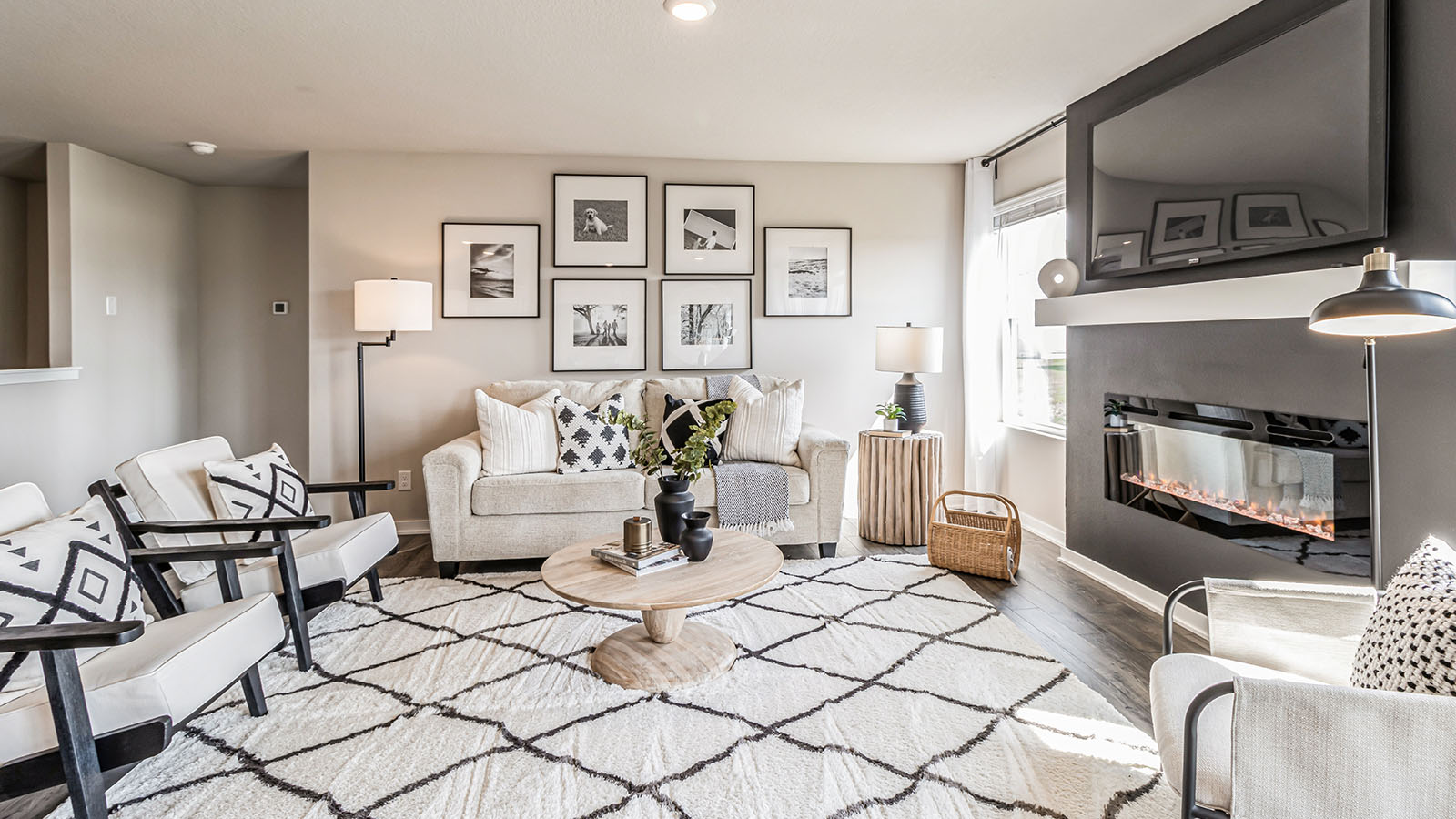Living room with electric or gas fireplace featuring open concept flow and natural light