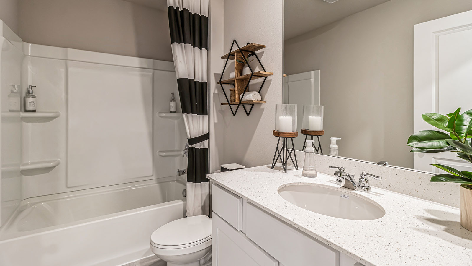 Family full bathroom adds stylish double vanity, mirror, cabinets, and tub-shower combo Three Lakes