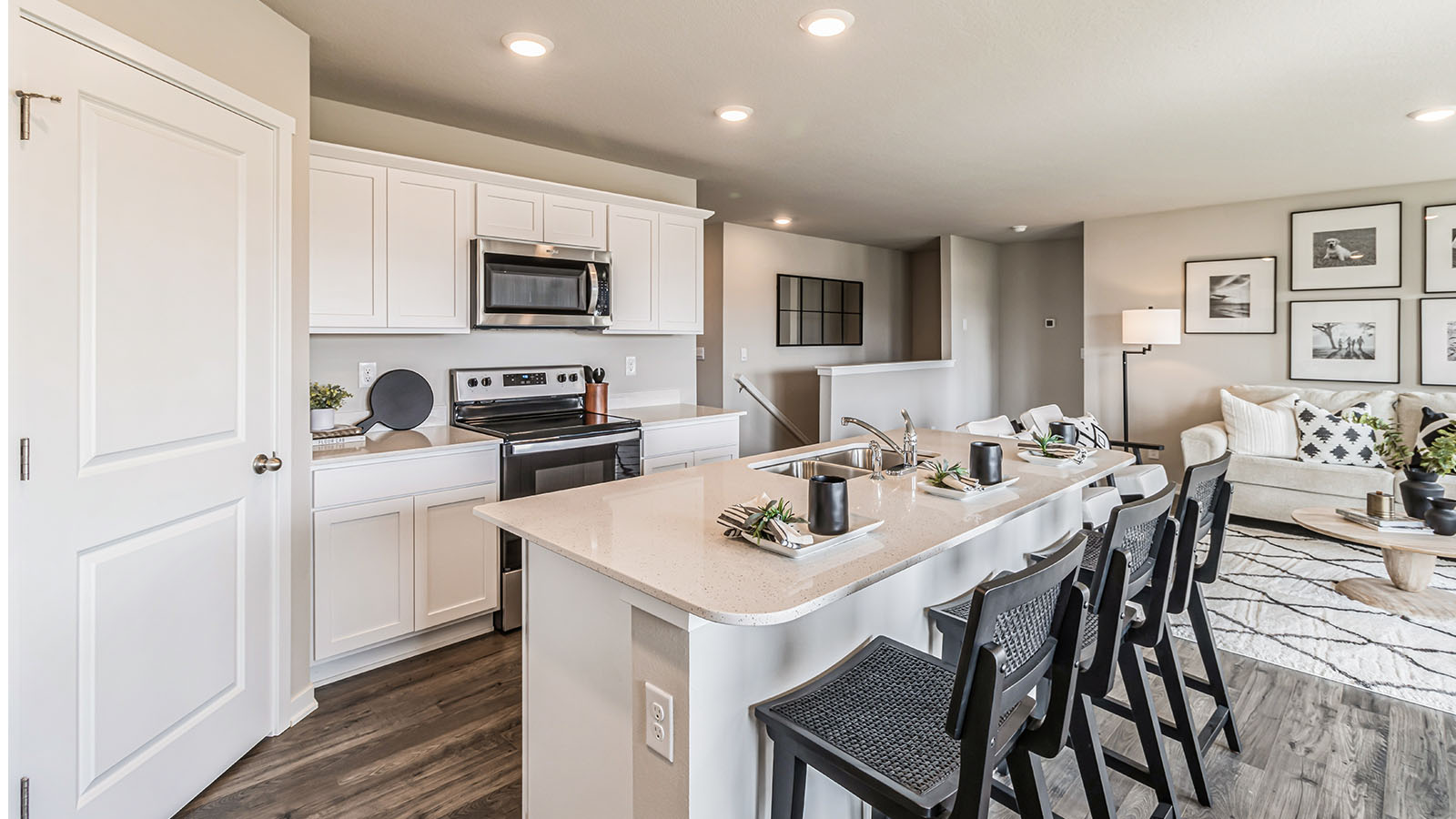 Central kitchen island anchors the home adding prep zones, pantry, and connectivity with appliance suite included Three Lakes