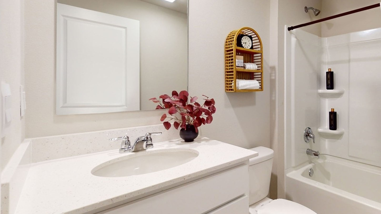 Second bathroom in basement with a mirror, sink, shower and bathtub