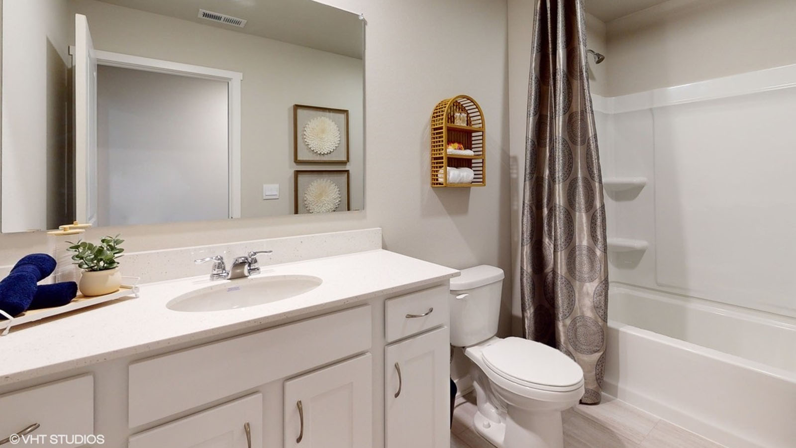 Bathroom with single vanity sink and step in shower.