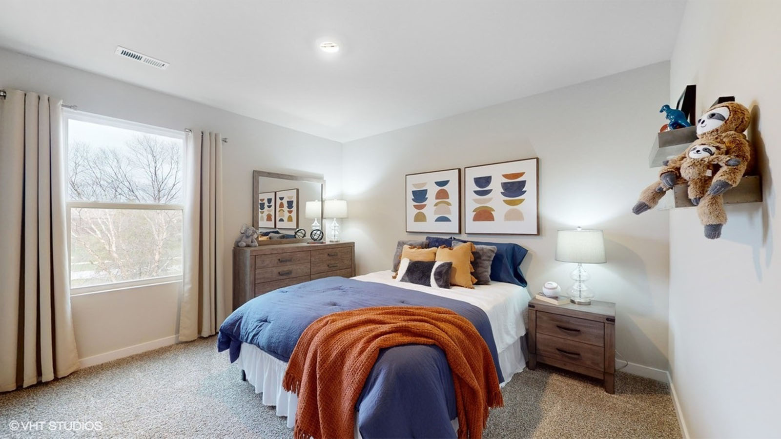 Bedroom with large window and carpeted floors.