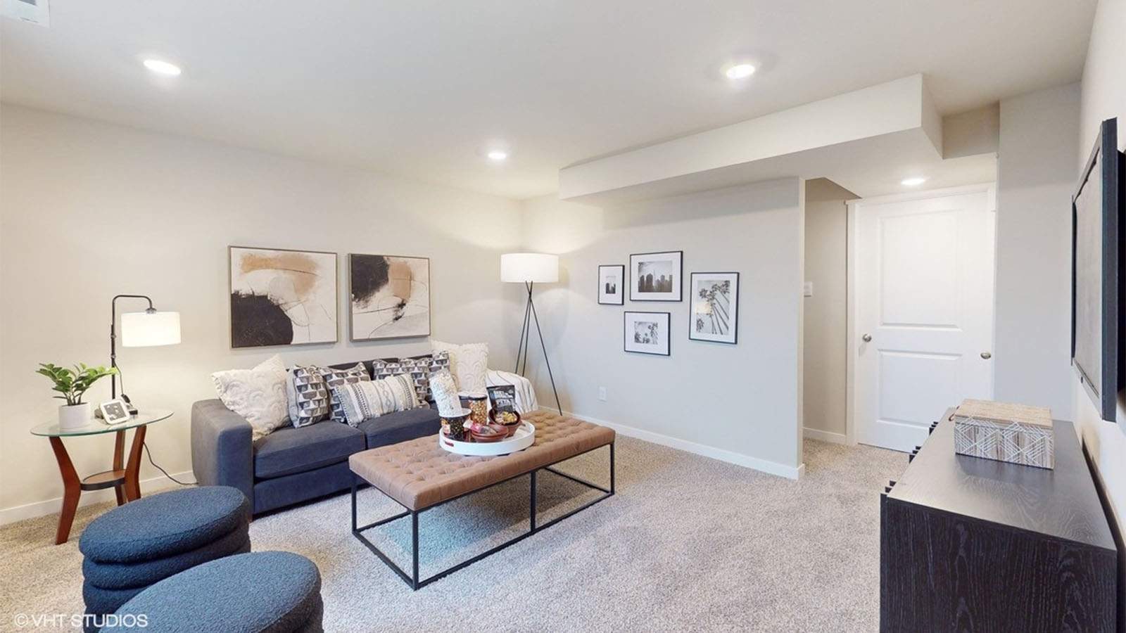 spacious finished basement with couch and mounted tv