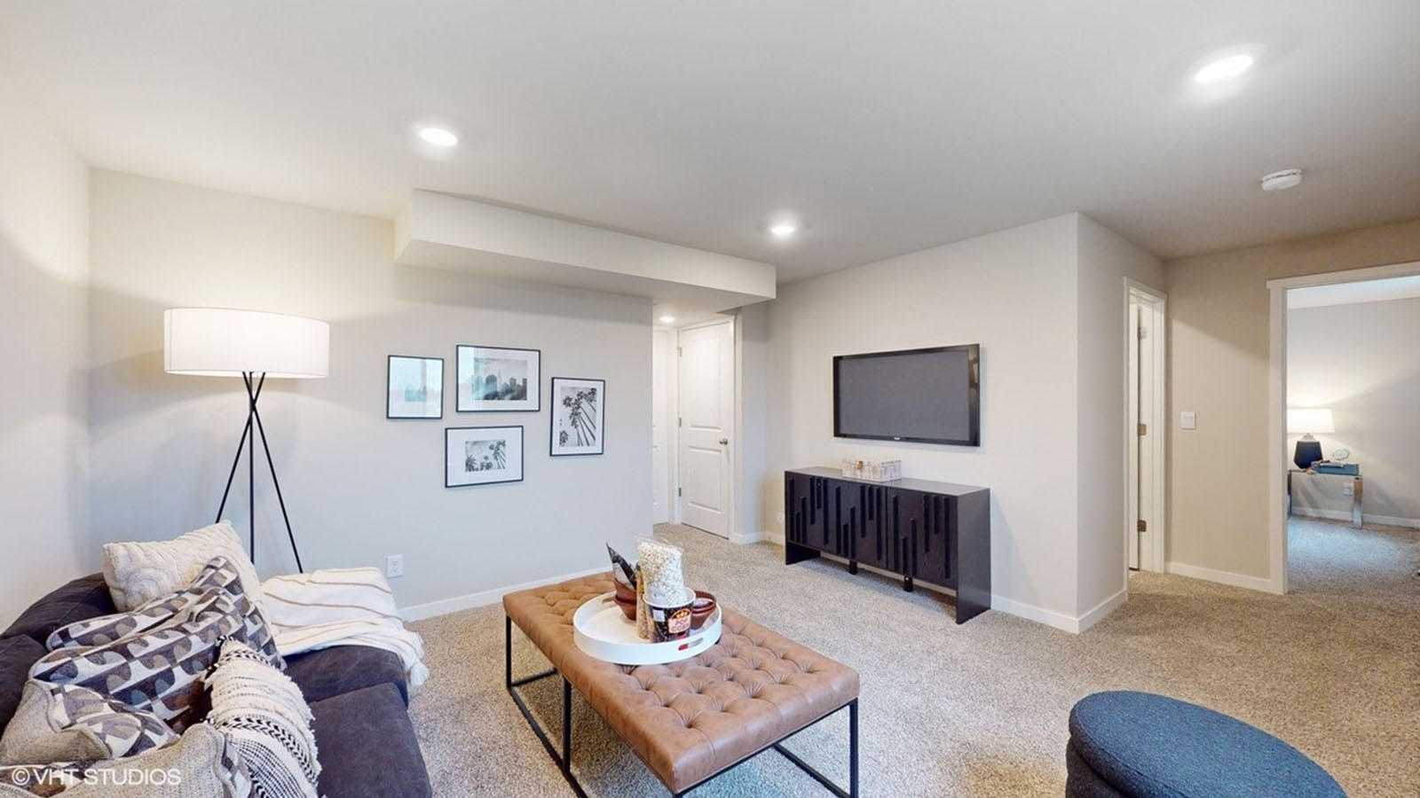 finished basement with lots of space and view of bedroom