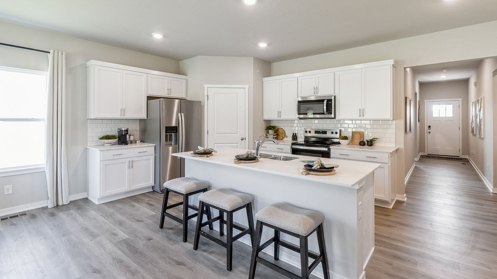 Kitchen with large island and quartz countertops.