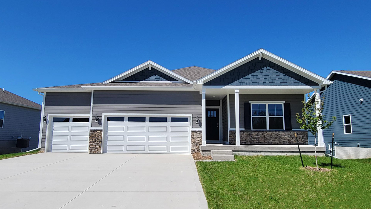 Front exterior of home with three car garage.