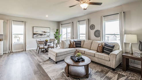 living room with two windows overlooking dining area