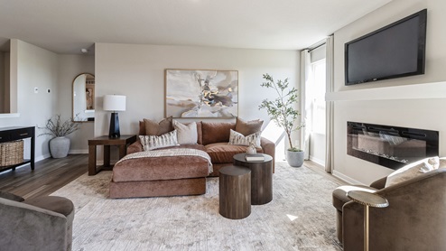 living room with electric fireplace and two small windows
