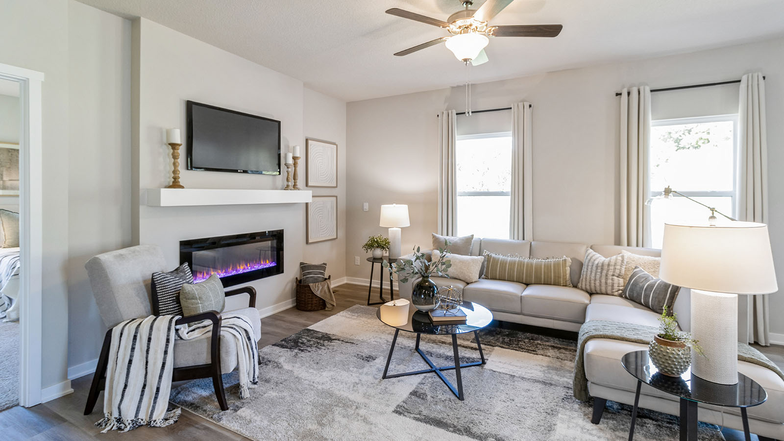 Bright living room with overhead tan and two windows