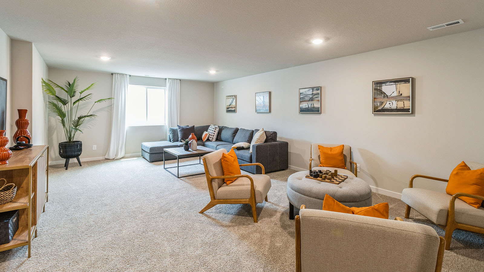 Spacious finished basement with window and overhead lighting