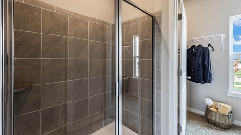Shower in primary bathroom with tile and glass shower doors