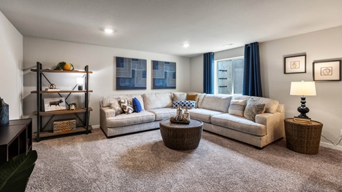 Finished basement with large sectional and egress window